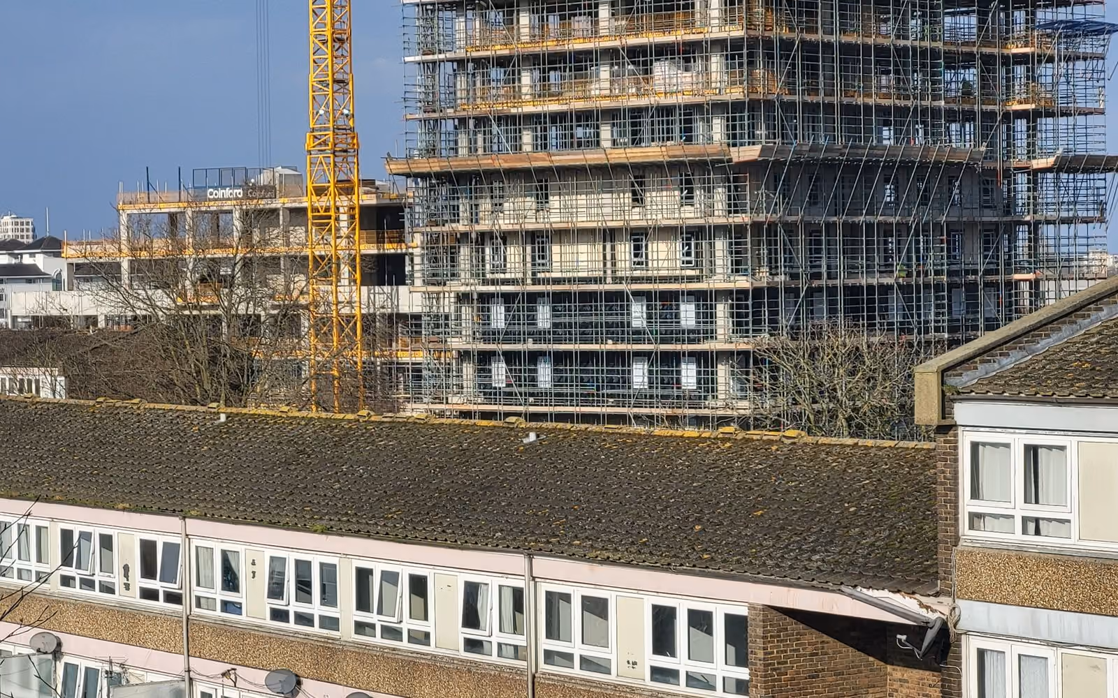 High-rise building under construction with a tower crane